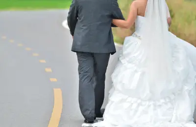 "Bride And Groom Walking Away On The Road" by Just2shutter